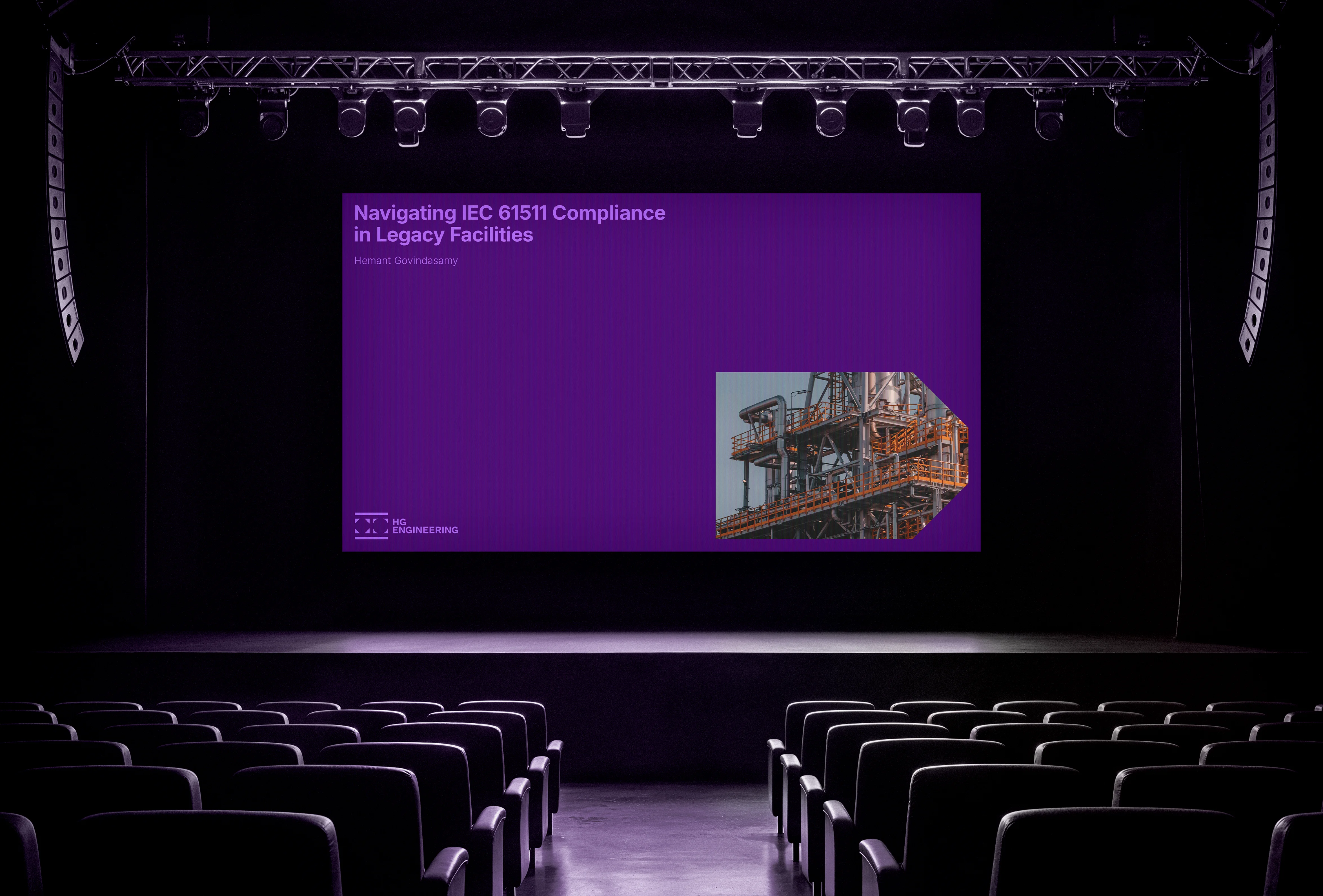 Empty auditorium with stage screen displaying the HG Engineering logo and title slide.