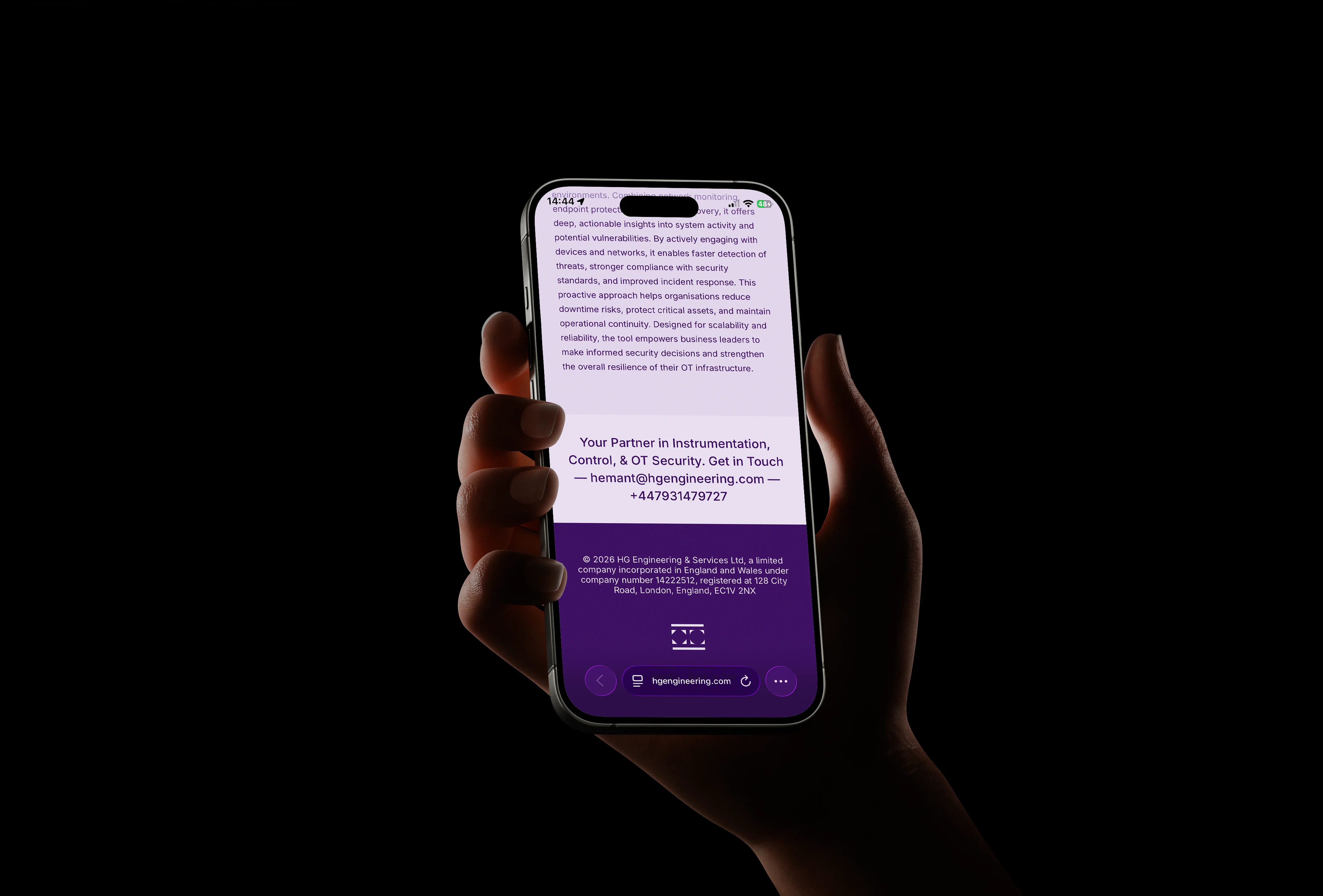 Close-up of a hand holding a smartphone showcasing the responsive layout of the HG Engineering website.